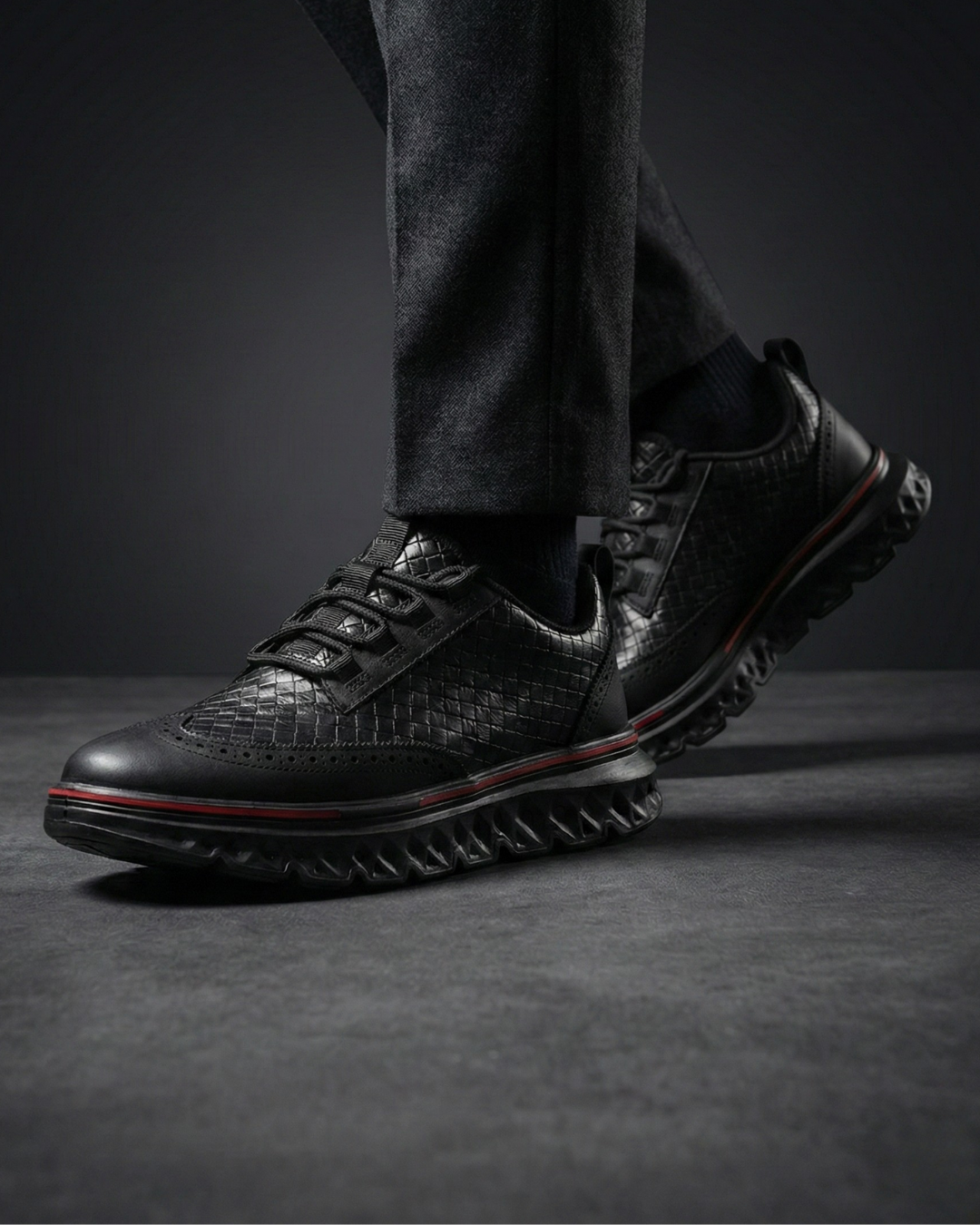 Black lace-up dress sneaker with textured upper and thick tread sole for grip