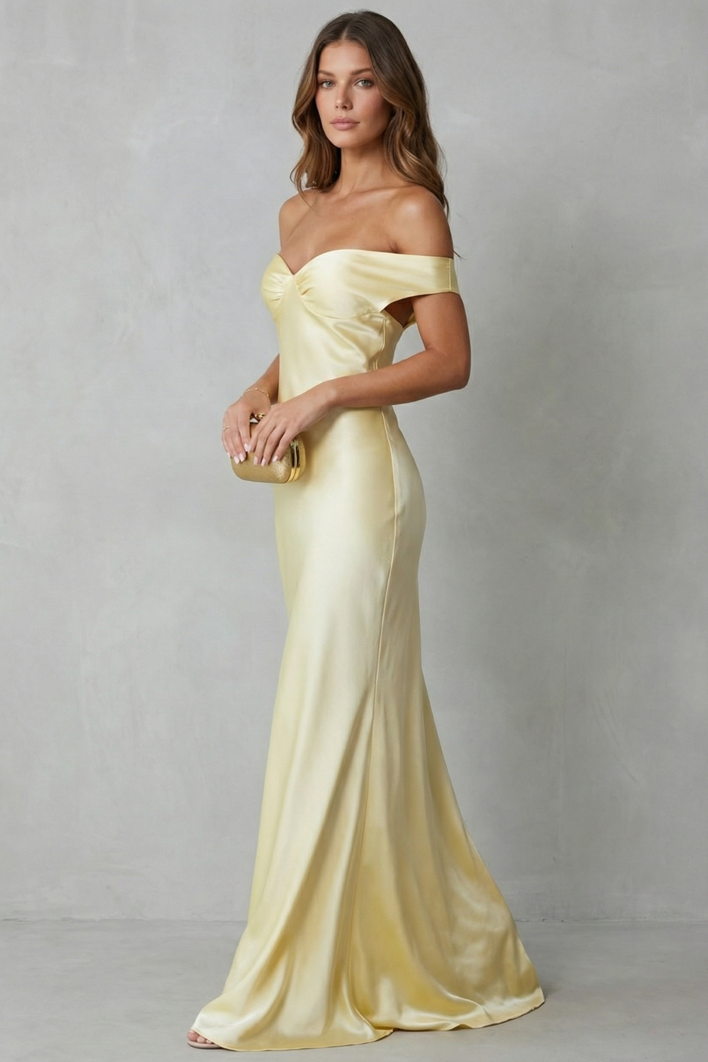 Yellow off-shoulder satin gown with layered neckline, fitted waist, long hem