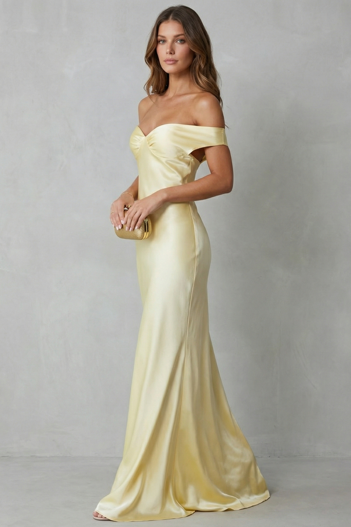 Yellow off-shoulder satin gown with layered neckline, fitted waist, long hem