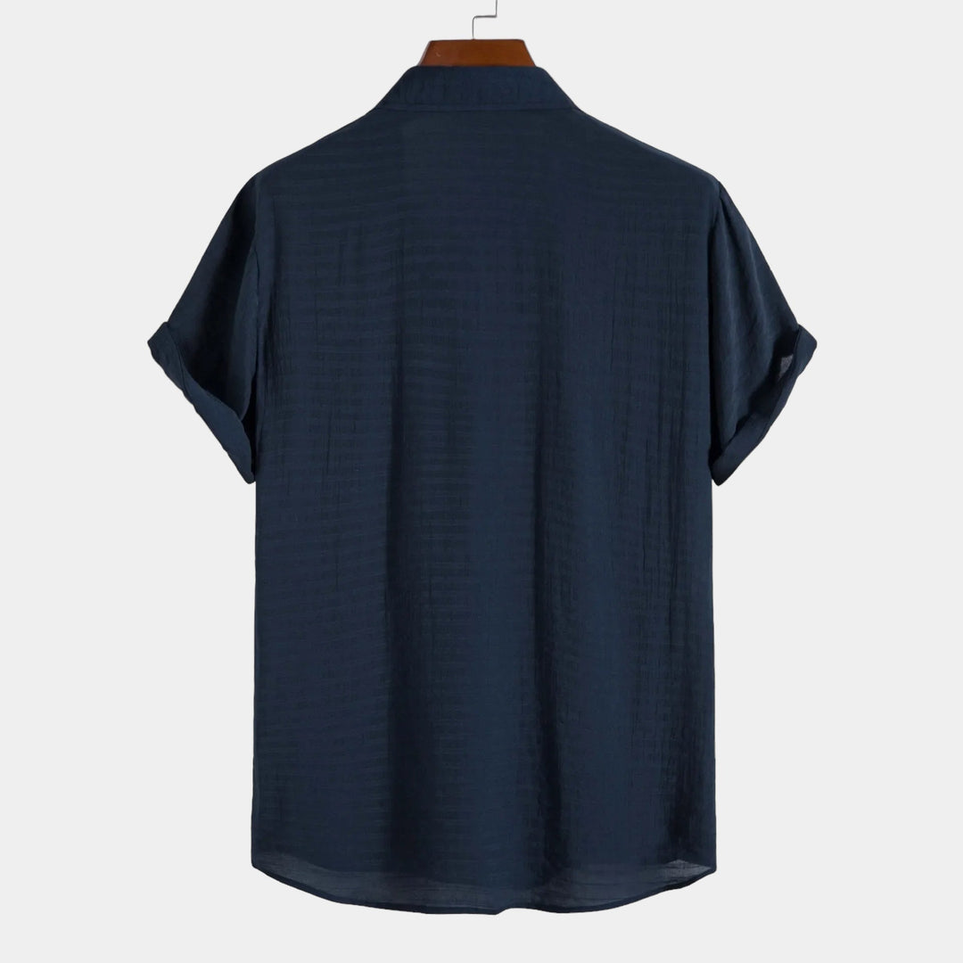 Navy short-sleeve summer shirt, back view with curved hem