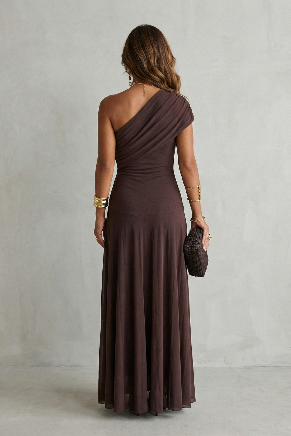 One-shoulder maxi dress in dark plum, shown from back with draped detail