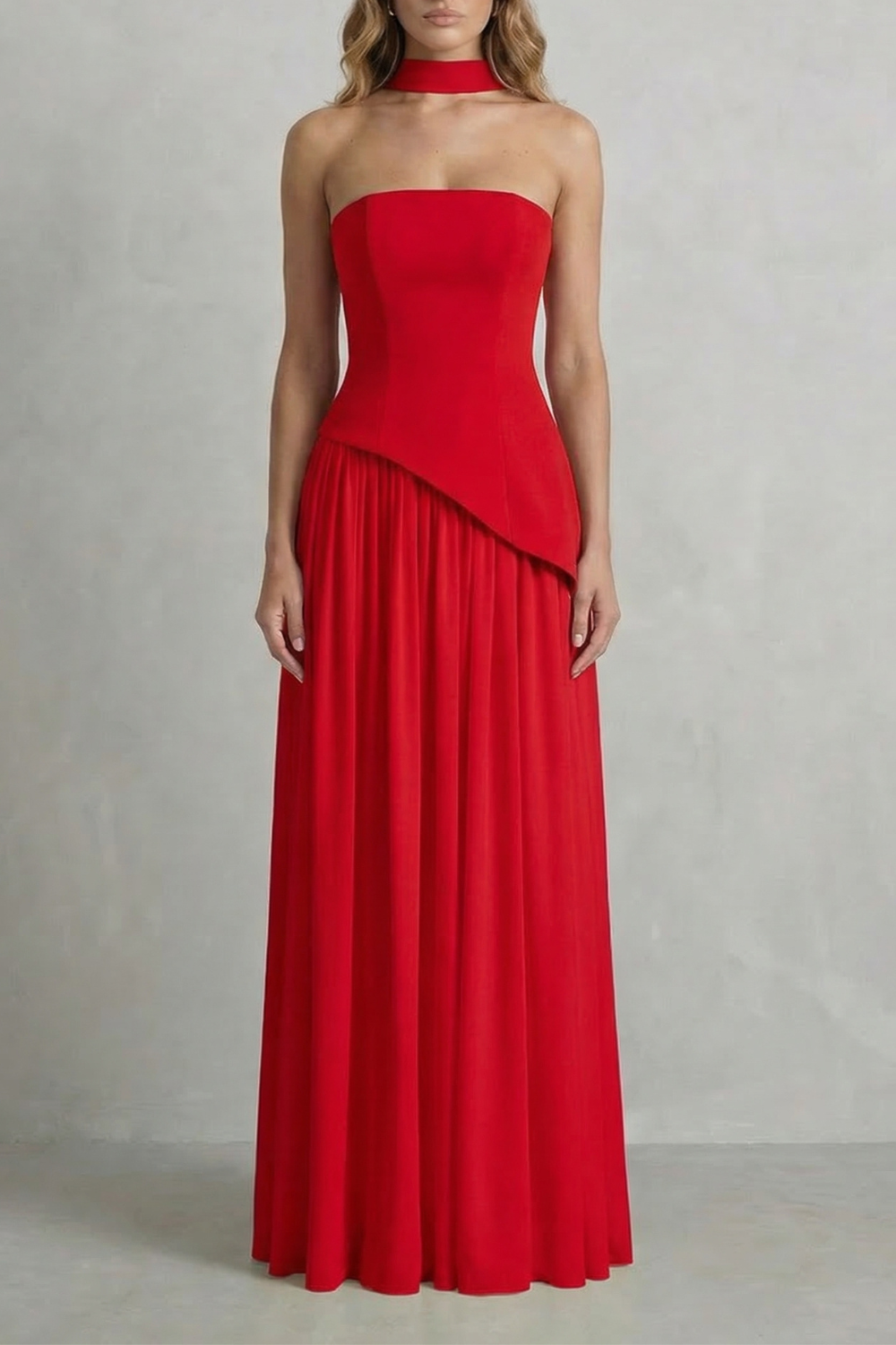 Red strapless draped maxi dress with diagonal overlay and pleated skirt