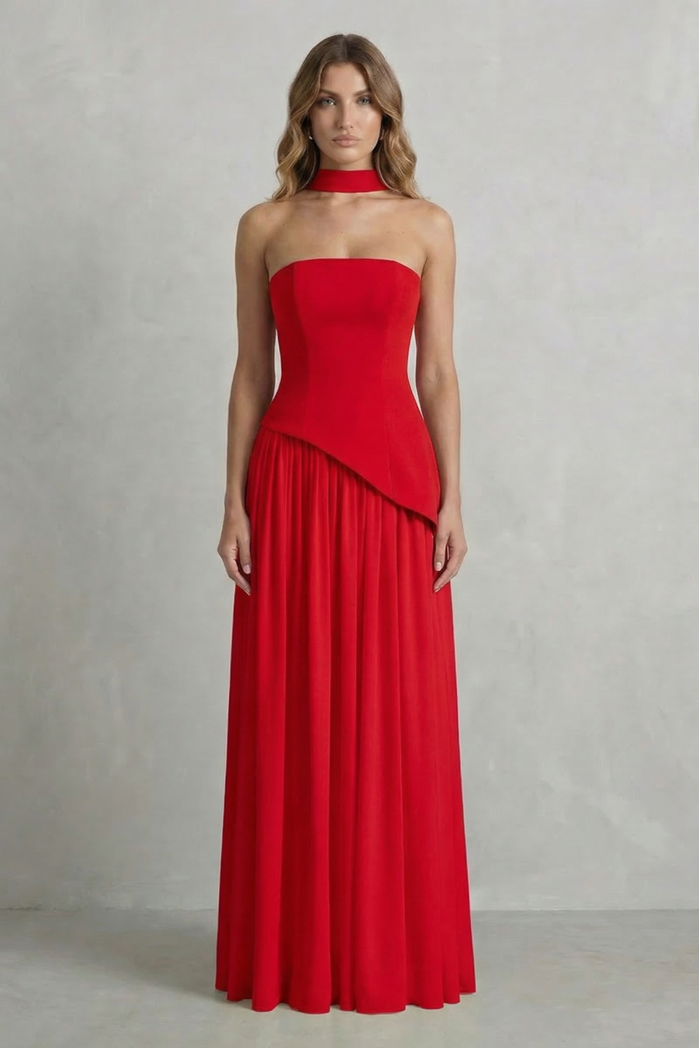 Red strapless draped maxi dress with asymmetric overlay and gathered pleat skirt