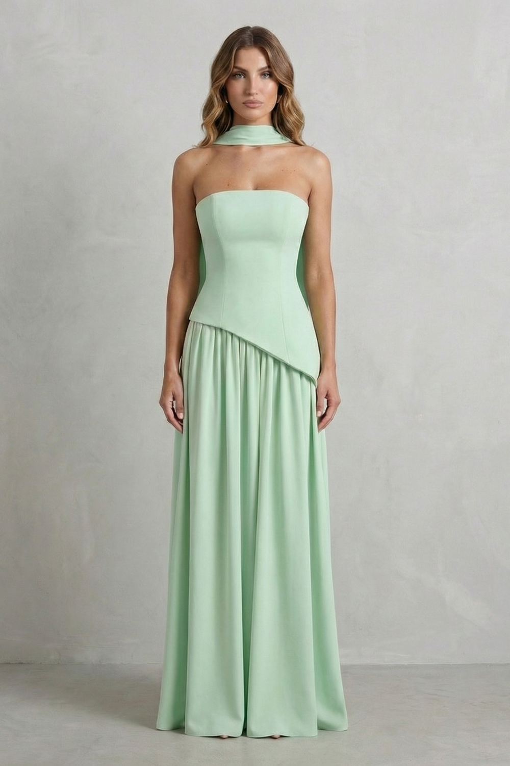Strapless maxi dress in mint green with draped diagonal hem and pleated skirt
