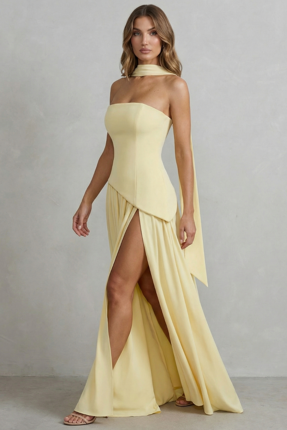Strapless yellow maxi dress with draped overlay and side slit at the skirt