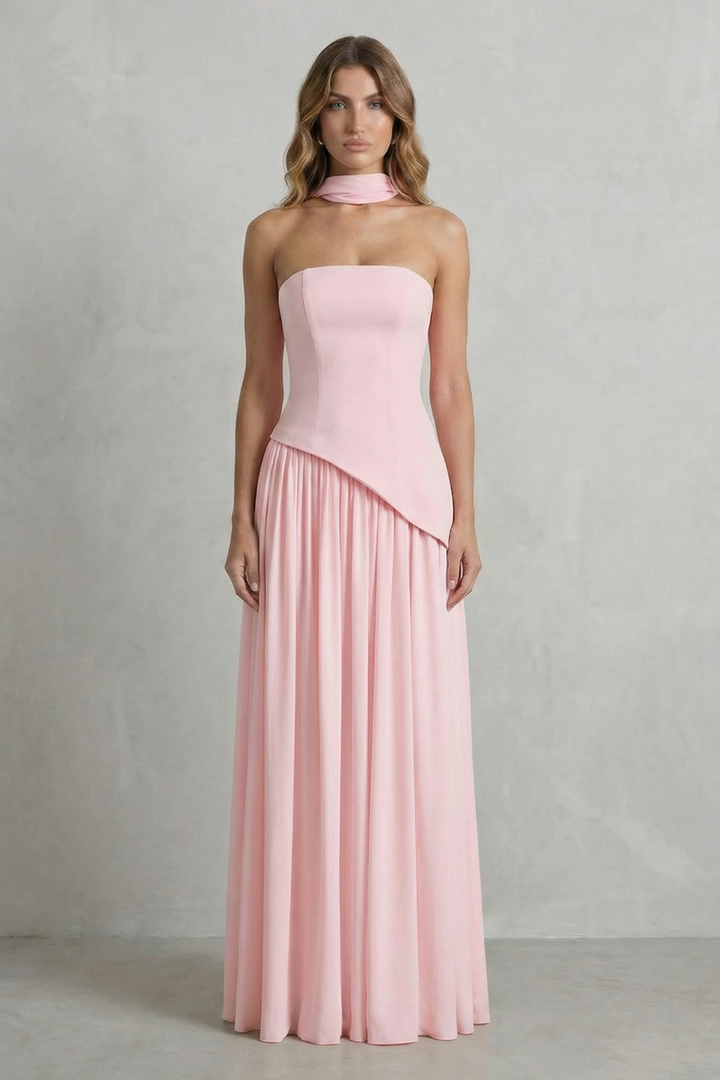 Strapless maxi dress in blush pink with draped diagonal hem and pleated skirt