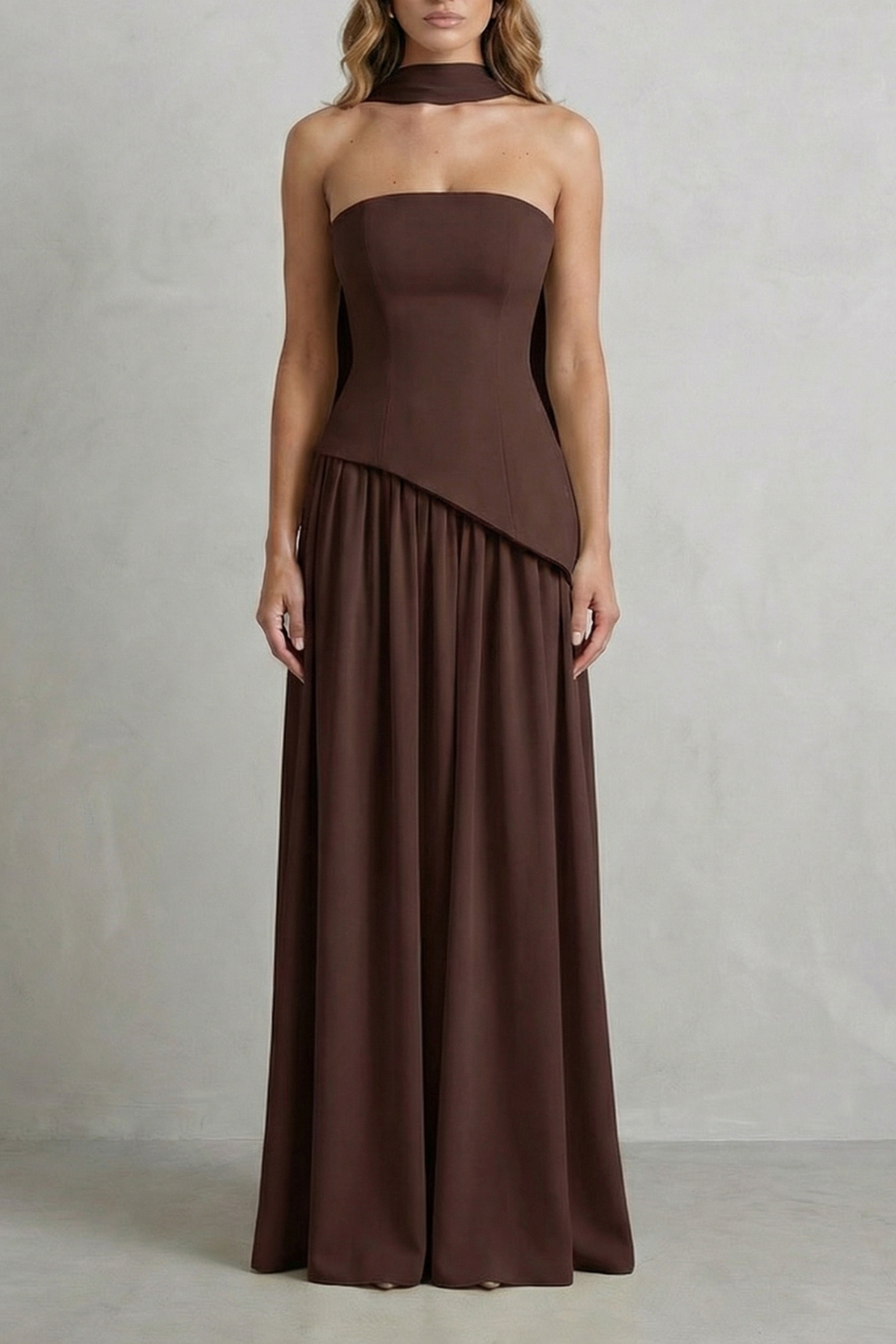 Dark brown strapless draped maxi dress with paneled bodice and flowing skirt