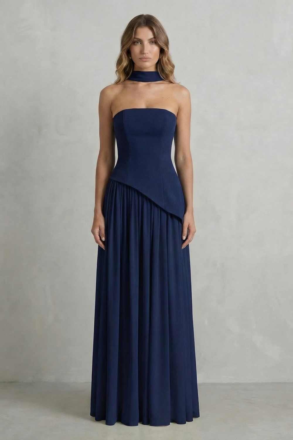Navy strapless draped maxi dress with diagonal overlay and gathered pleat skirt