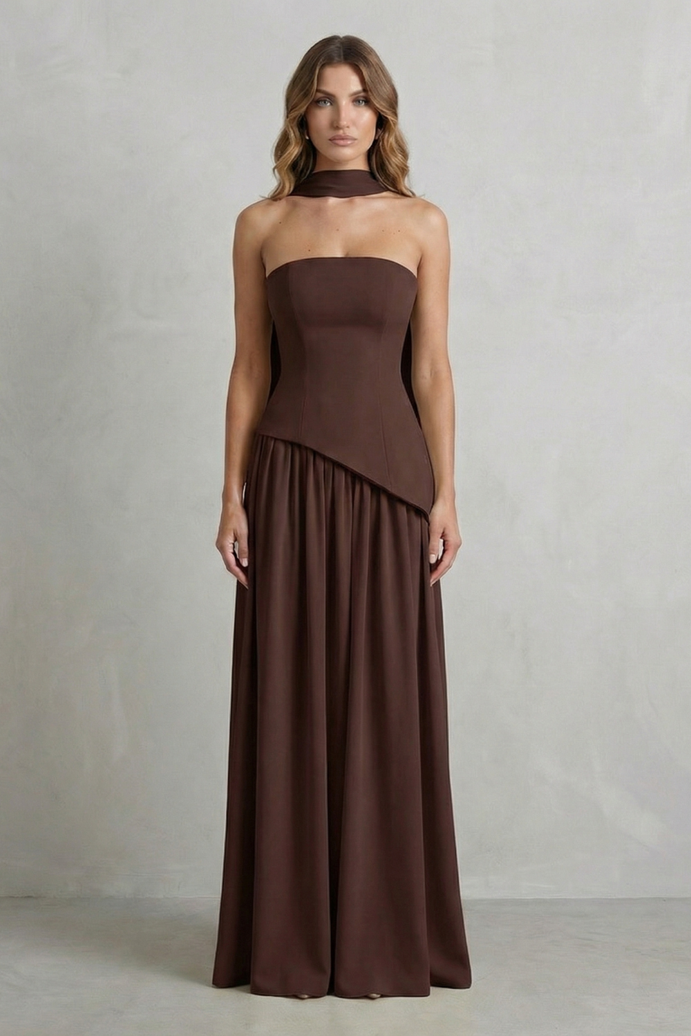 Dark brown strapless maxi dress with draped corset-style bodice and gathered skirt