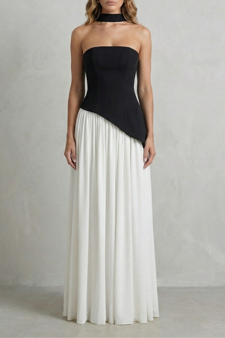 Black strapless draped maxi dress with diagonal overlay and pleated white skirt