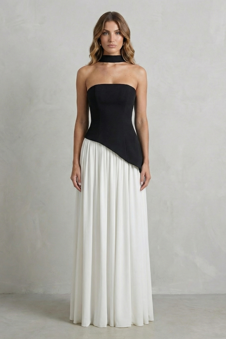 Black strapless draped maxi dress with diagonal overlay and pleated white skirt