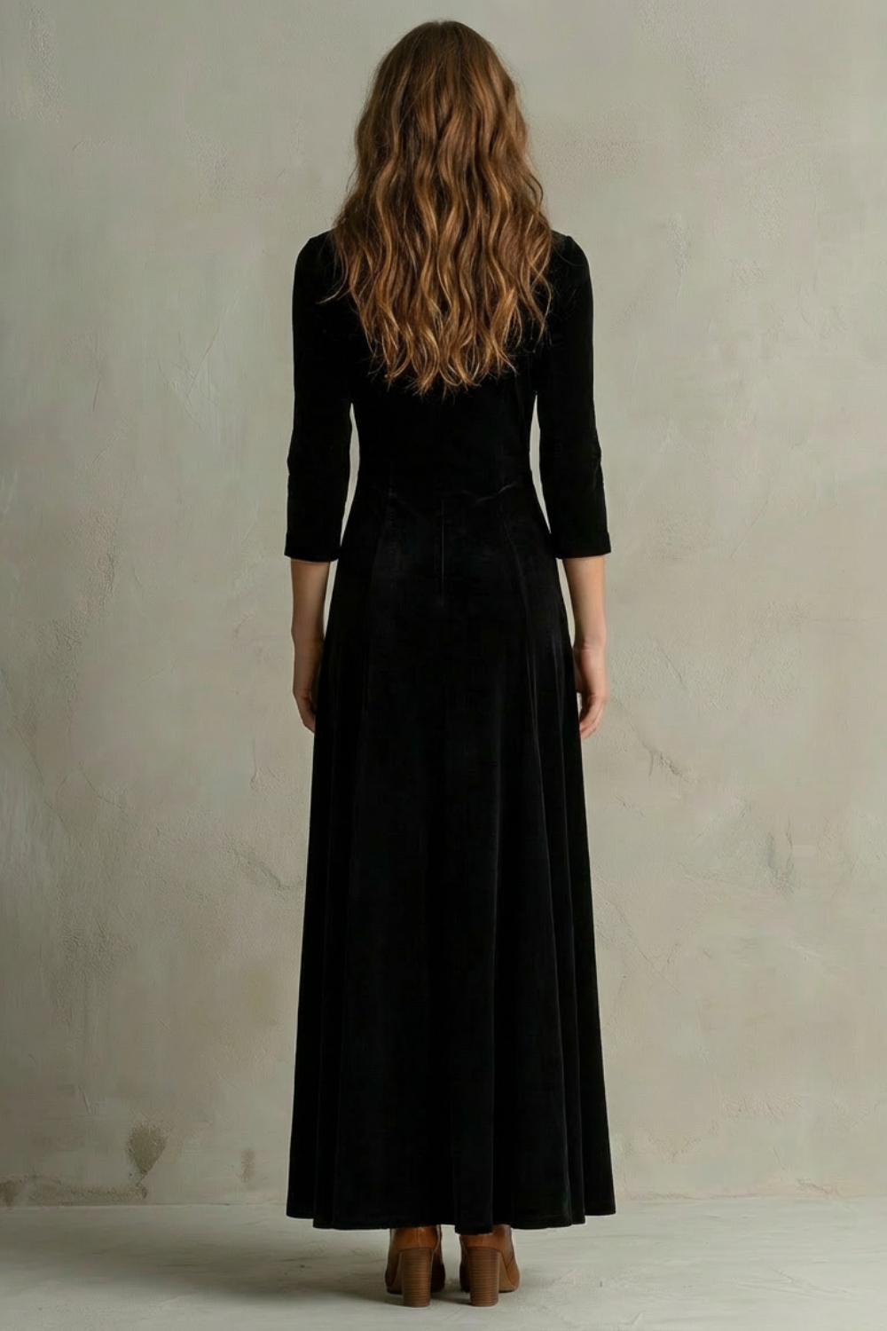 Back view of black velvet maxi dress with fitted waist and long column skirt