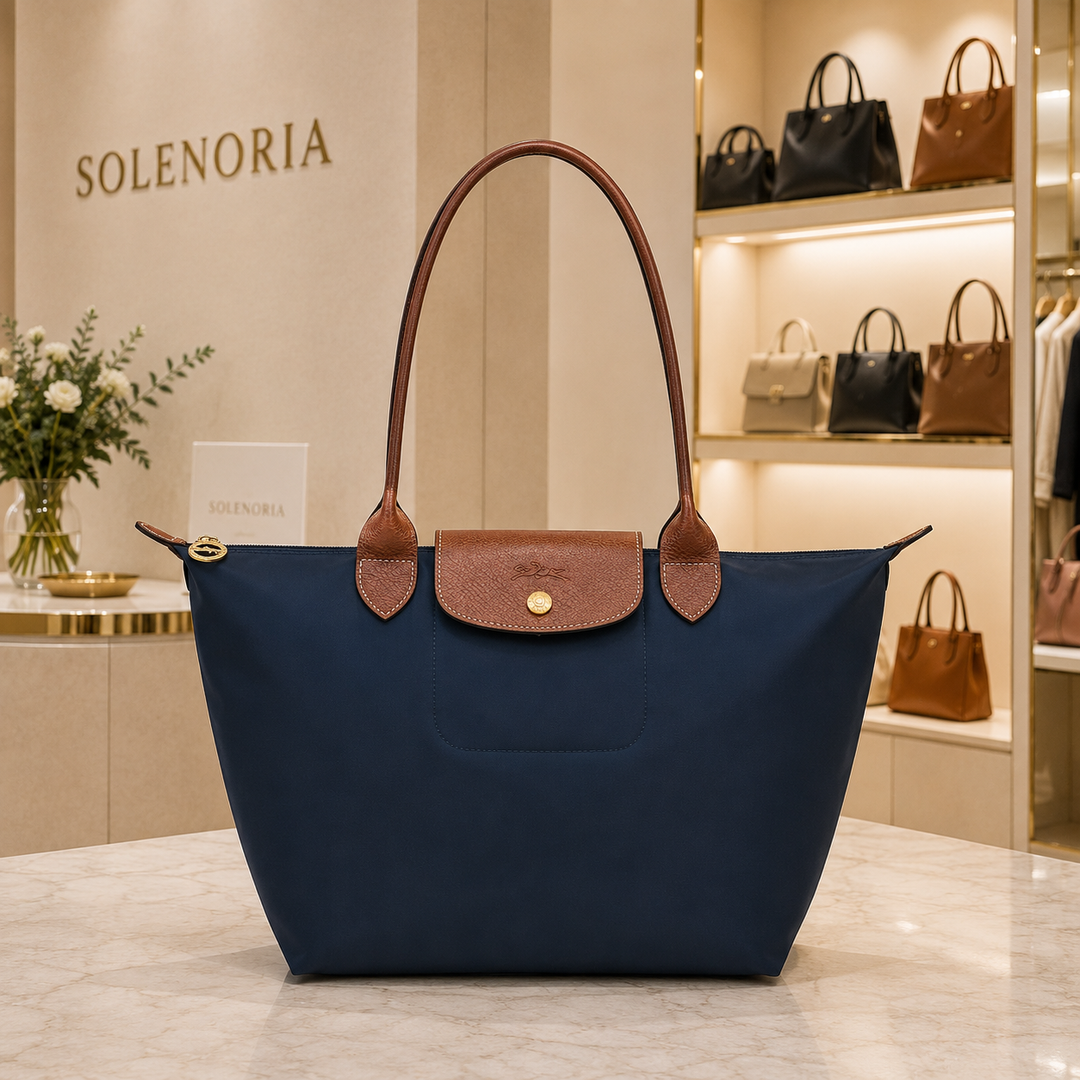 Medium navy tote bag with brown leather trim, handles, front pocket and snap flap