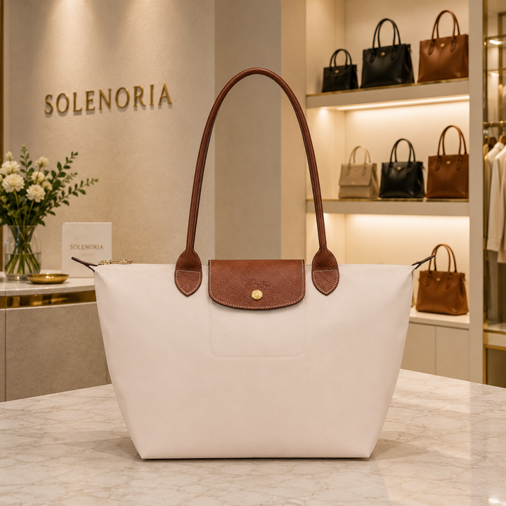Medium paper tote bag with brown leather trim, top handles, front flap pocket