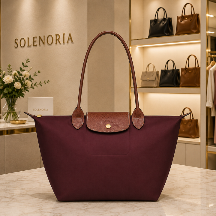 Medium burgundy leather tote bag with top handles and flap pocket