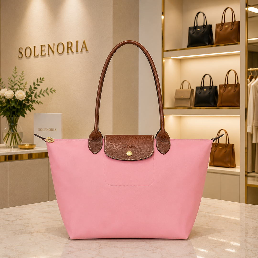 Medium pink tote bag with brown leather handles and front pocket