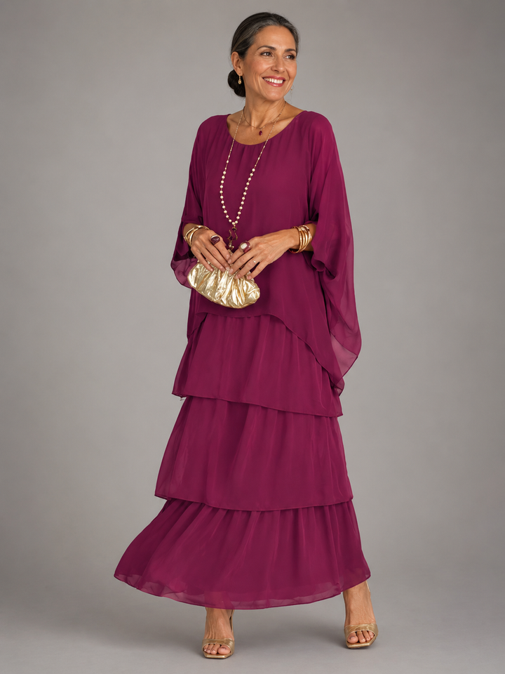 Purple tiered maxi dress with loose cape sleeves and flowing layered skirt