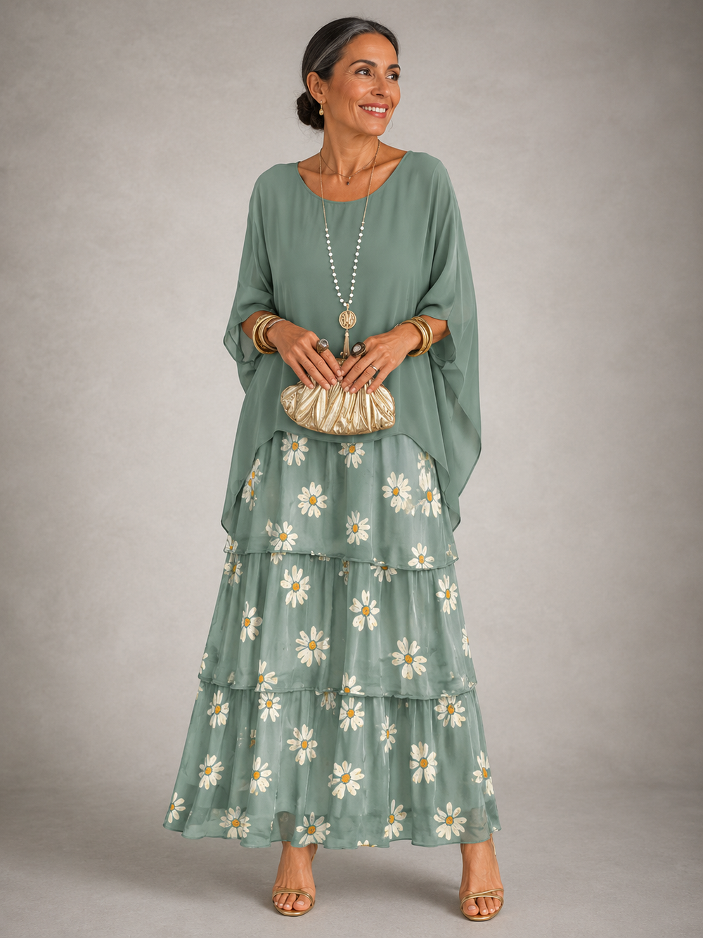 Sage green maxi dress with tiered skirt and embroidered daisy detail at hem