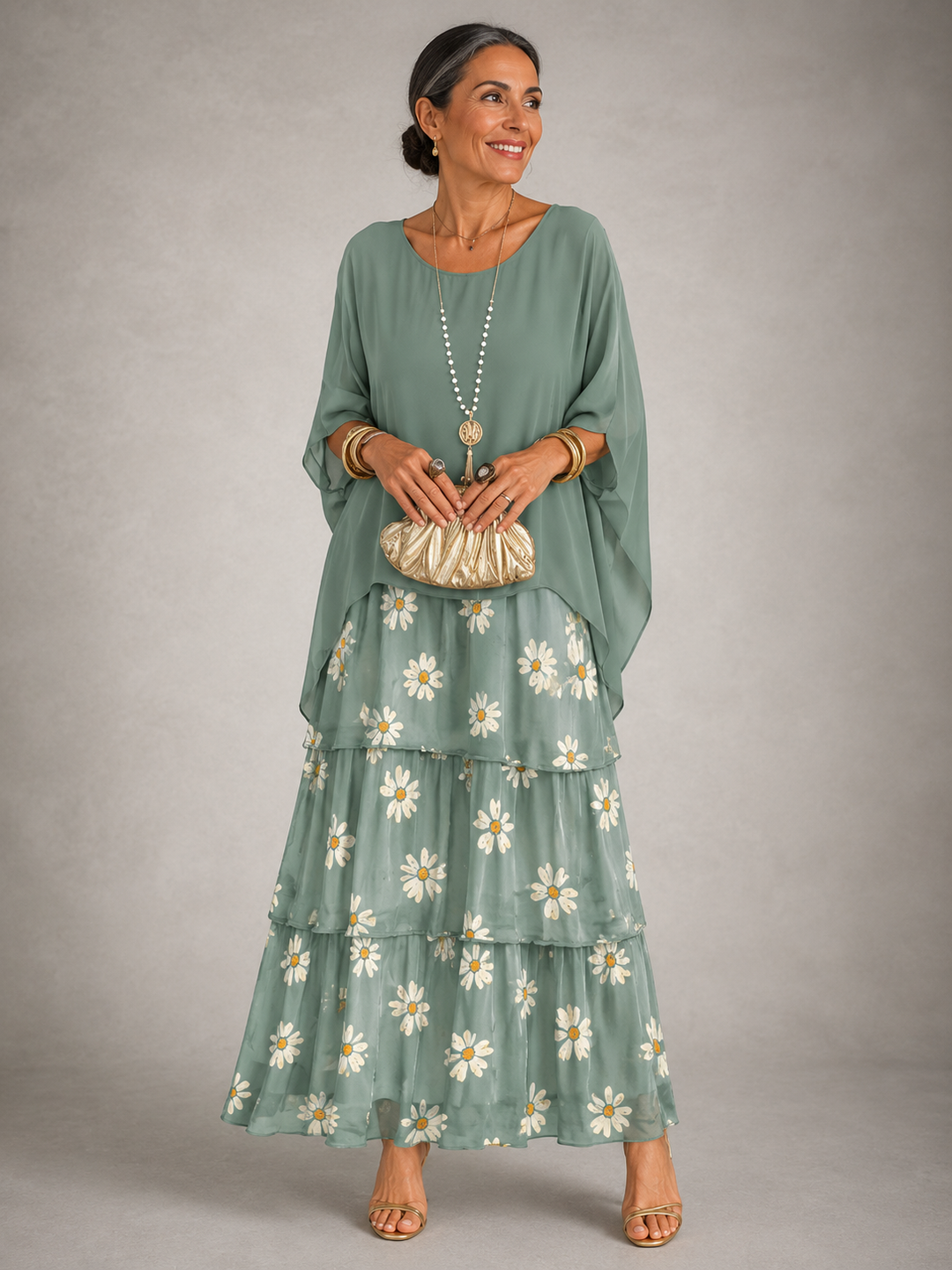 Sage green maxi dress with tiered skirt and embroidered daisy detail at hem