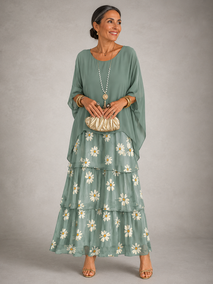 Sage green maxi dress with tiered skirt and embroidered daisy detail at hem