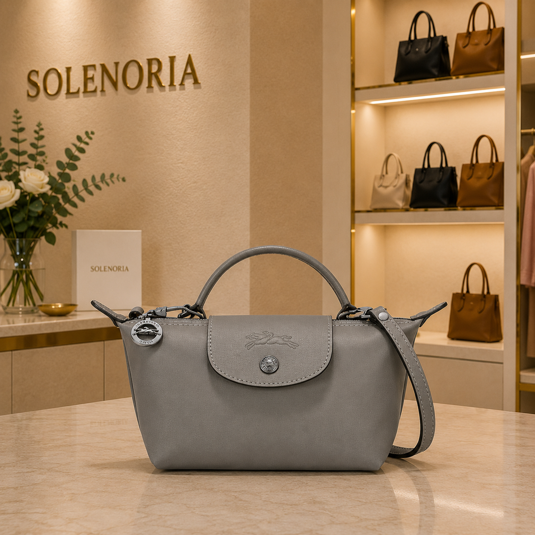 Grey mini leather tote bag with front flap, top handle, and adjustable shoulder strap