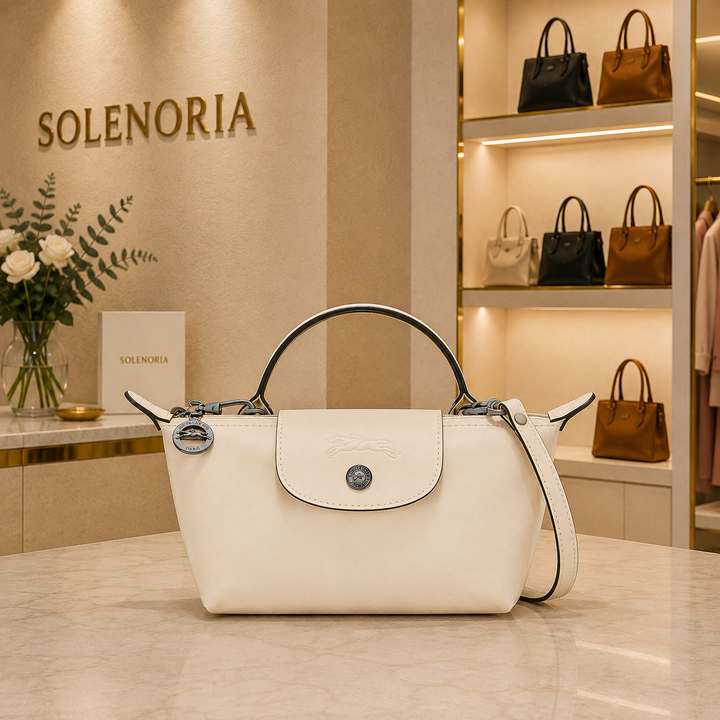 Mini white leather tote bag with front flap pocket and adjustable shoulder strap