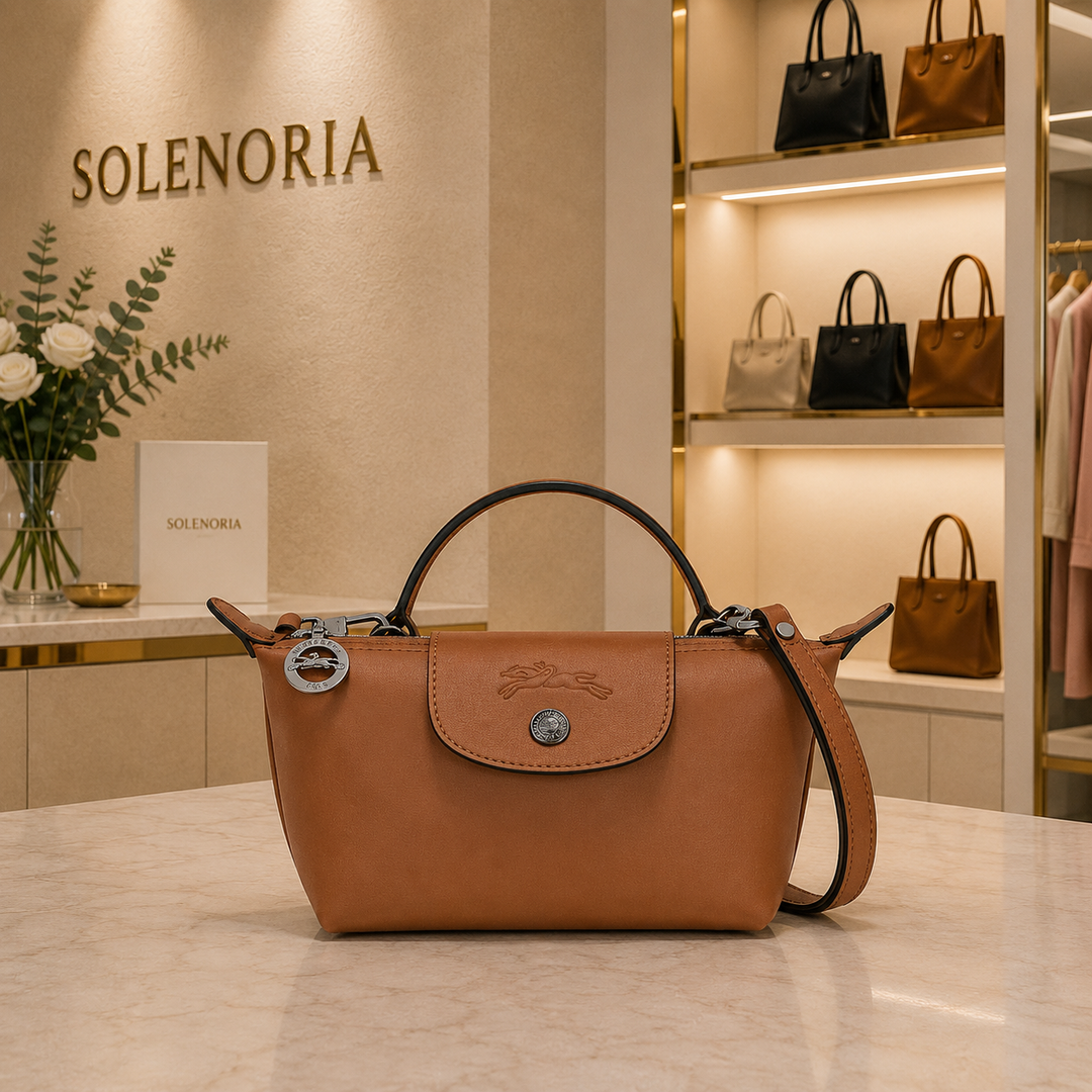 Mini brown leather tote bag with front flap and metal clasp, top handles and shoulder strap