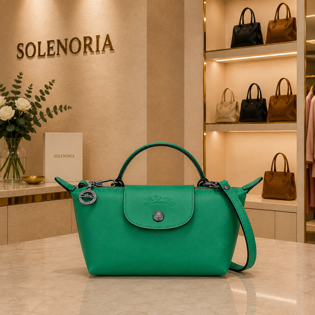 Mini green leather tote bag with front flap pocket, top handles, and crossbody strap