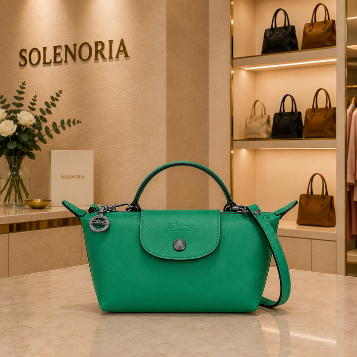 Mini green leather tote bag with front flap pocket, top handles, and crossbody strap