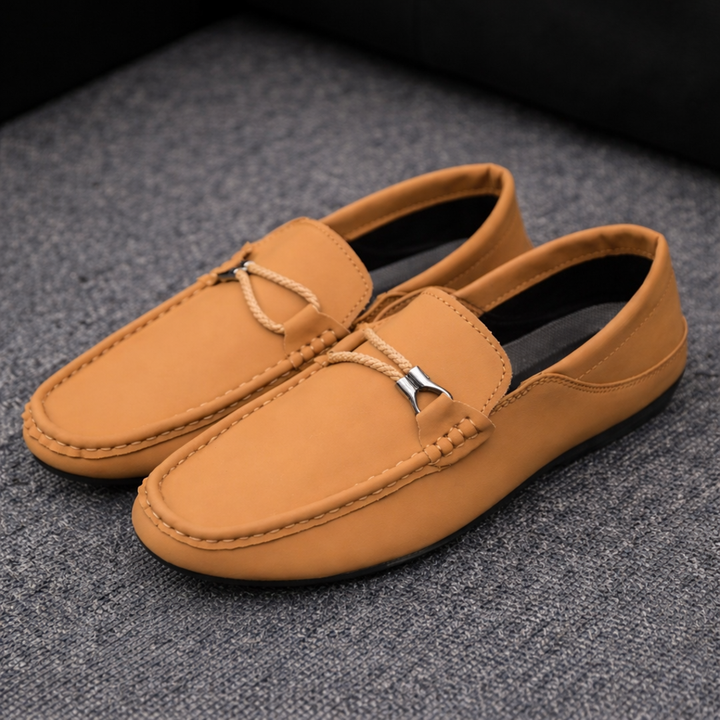 Brown casual loafers with braided strap detail and metal buckle