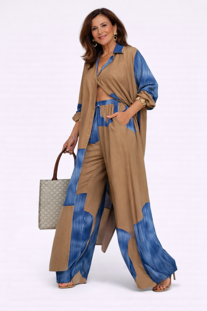 Tan and blue flowing two-piece set with long draped jacket and wide-leg pants, blue print