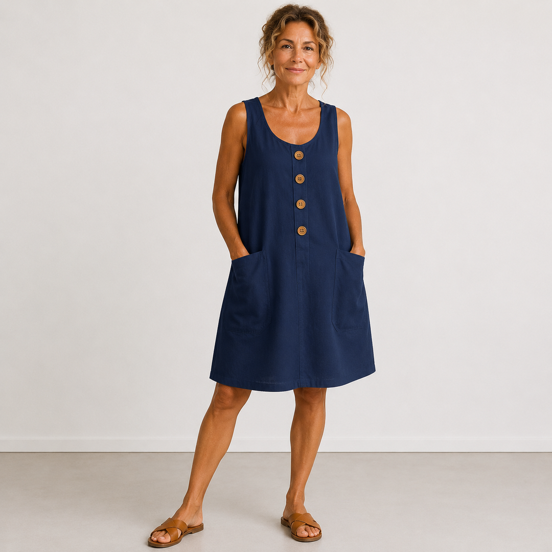 Blue sleeveless linen dress with button front and side pockets, relaxed A-line fit.