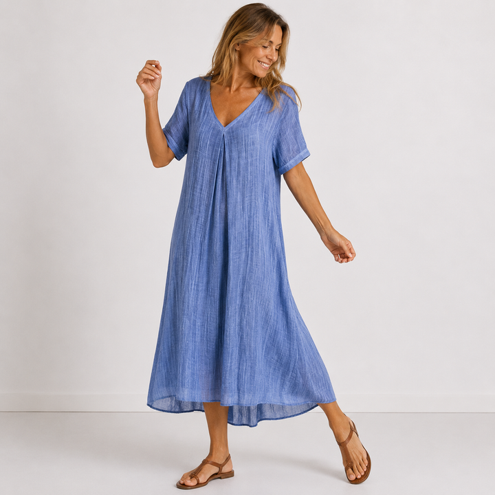 Blue linen V-neck midi dress with short sleeves, relaxed fit, and flowing hem