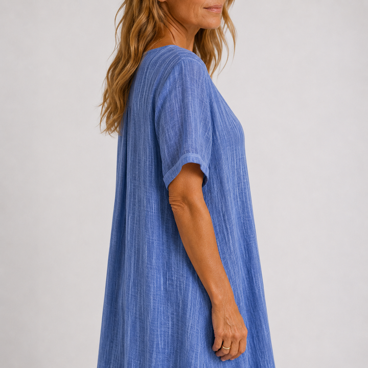 Blue linen V-neck midi dress side view with short sleeves and loose drape