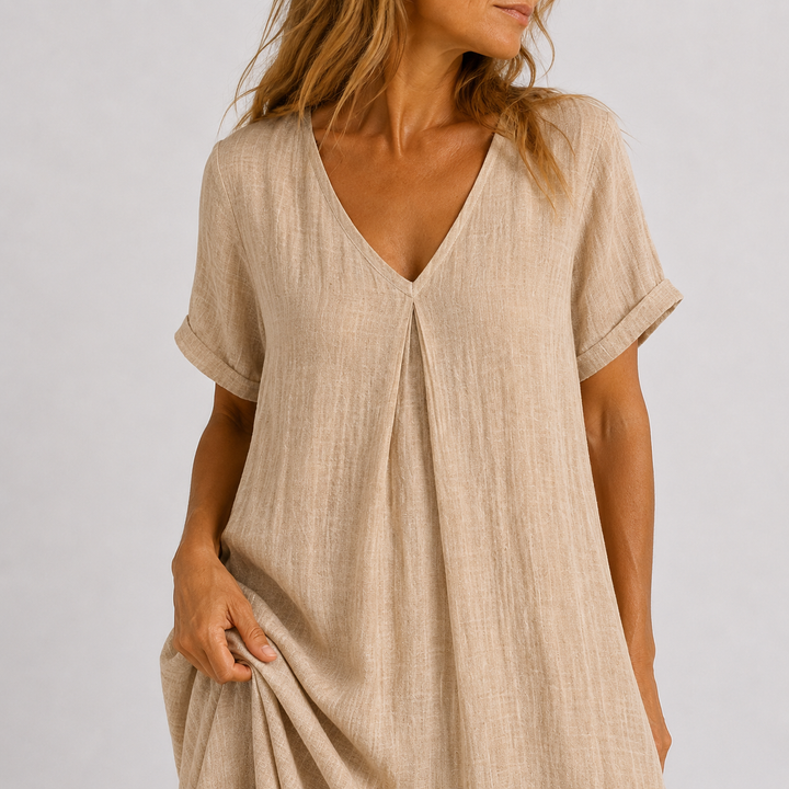 Beige linen V-neck dress close-up with short sleeves and gathered button front