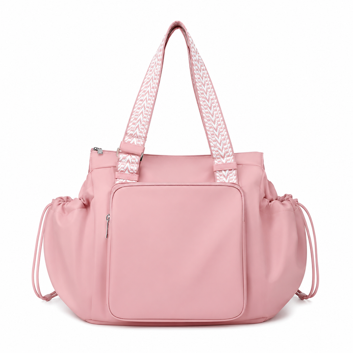 Pink 3-in-1 organized tote bag with front pocket, ruffled sides, and patterned shoulder straps