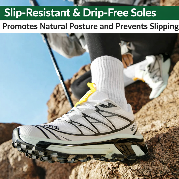 Women’s lace-up walking sneaker in white with black panels and yellow pull tab on rocks