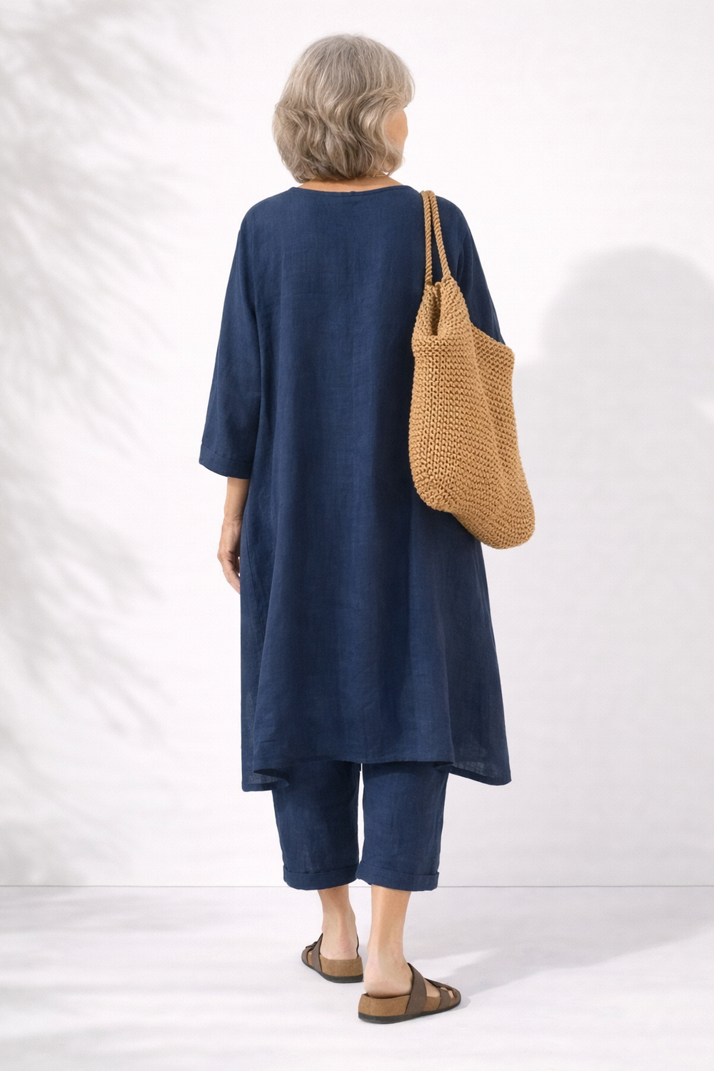 Navy two-piece set, back view, long V-neck layered tunic and wide-leg pants