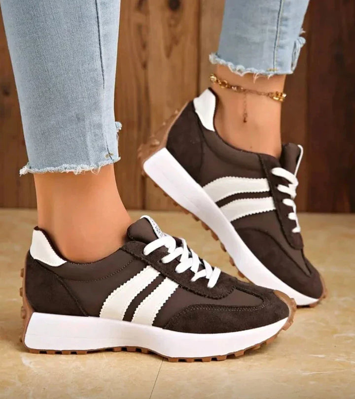 Brown and white lace-up sneakers with striped side panels and flat rubber sole