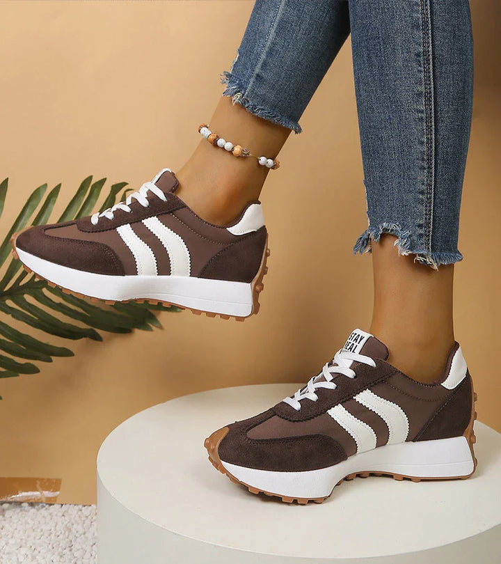 Dark brown and white lace-up sneakers with striped side panels and brown tread