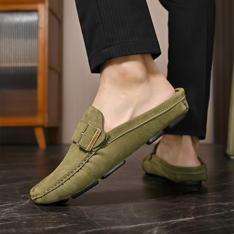 Olive suede loafers on model, slip-on design with front buckle strap