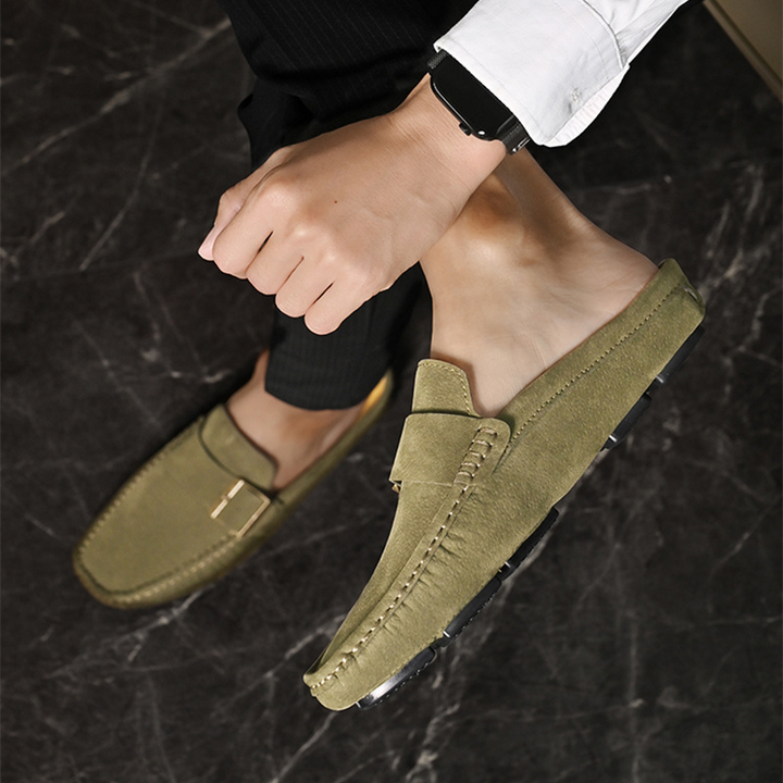 Olive suede loafers, side view showing buckle strap and contrast stitching