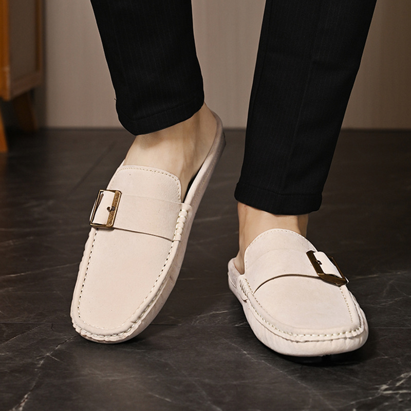 Cream suede loafers with metal buckle strap, front view on feet
