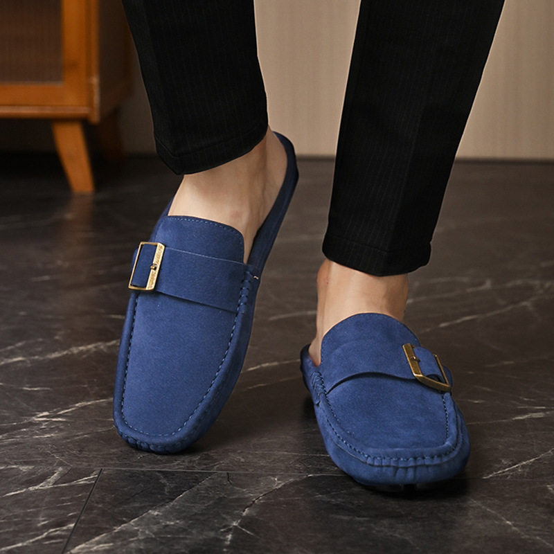 Navy suede loafers with gold buckle strap, side view