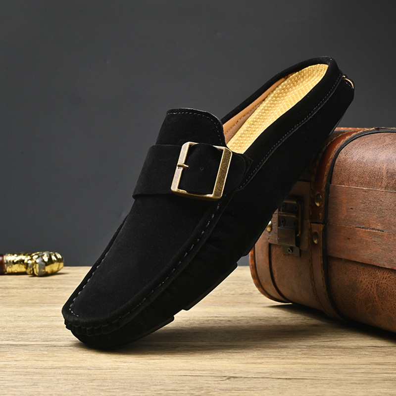 Black suede loafers with metal buckle strap and stitched moccasin edge