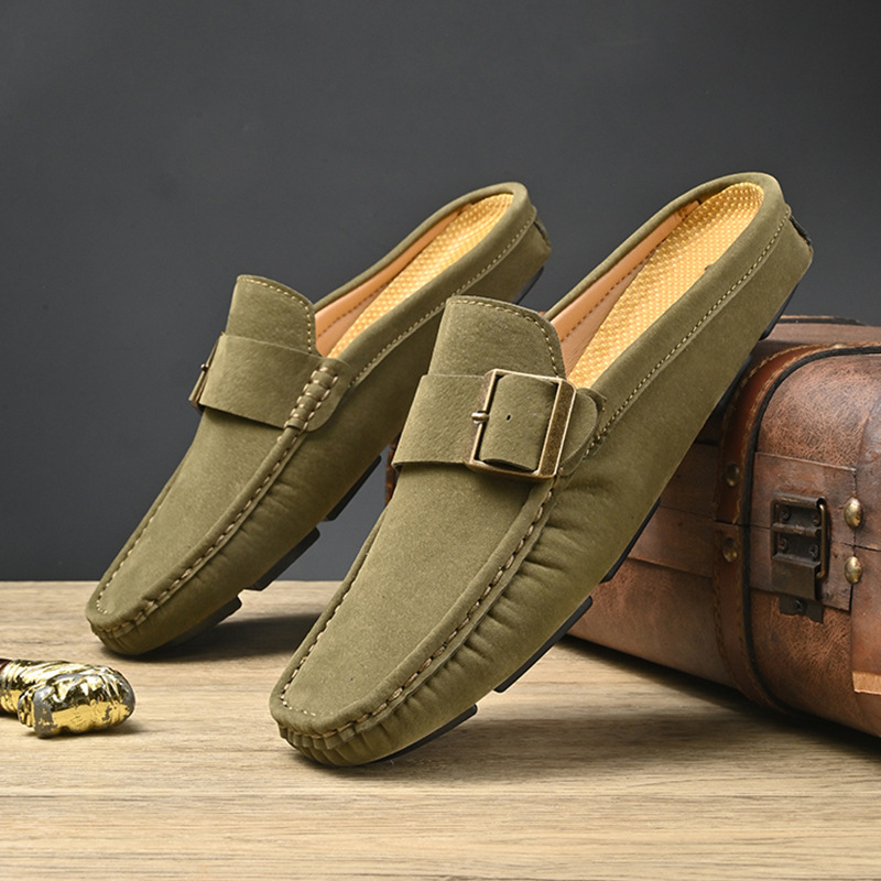 Pair of olive suede loafers with gold buckle strap and low-profile sole