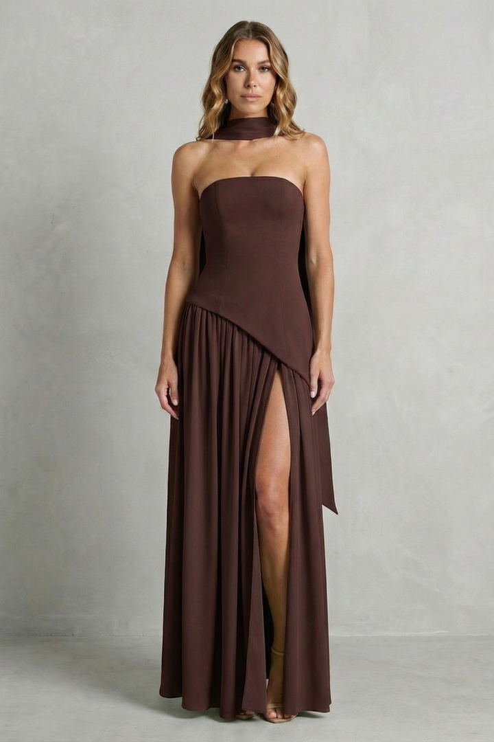 Brown strapless formal gown with draped bodice and pleated skirt with leg slit