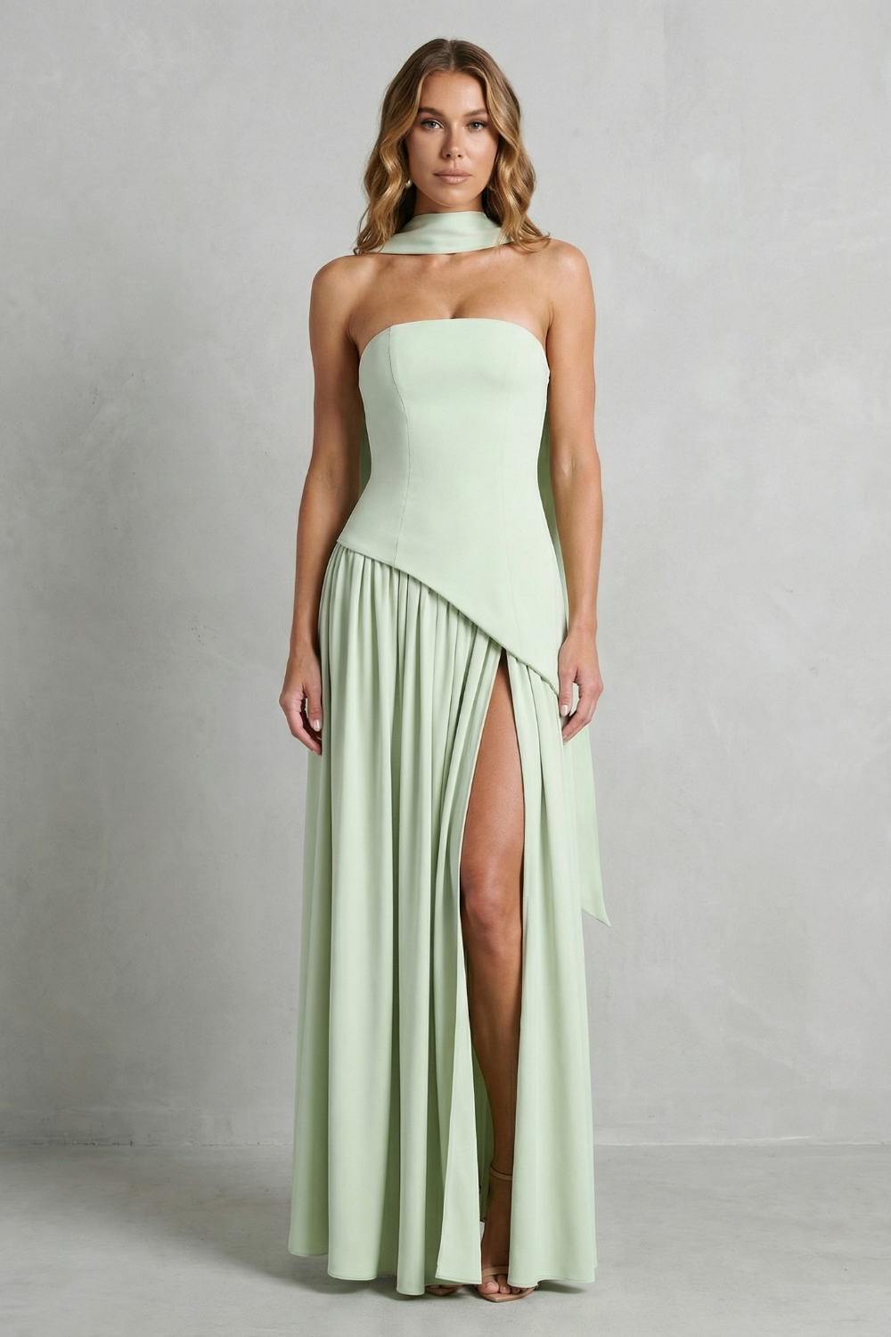 Mint green strapless formal gown with draped bodice and pleated skirt with slit