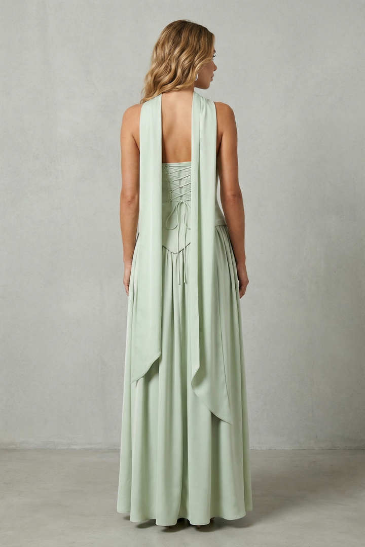 Mint green strapless gown from the back with draped pleated skirt and open back