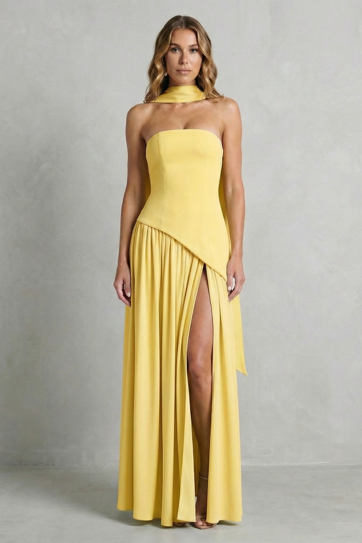 Yellow strapless formal gown with draped bodice and pleated skirt with high slit